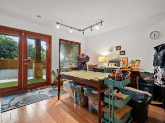 Unleash your creativity in this dedicated craft room, featuring a spacious cutting table and ample storage solutions.