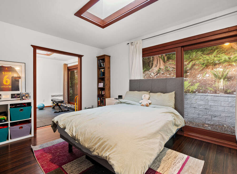This bedroom offers a comfortable retreat with a plush bed and a cozy reading nook.
