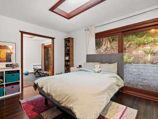 This bedroom offers a comfortable retreat with a plush bed and a cozy reading nook.
