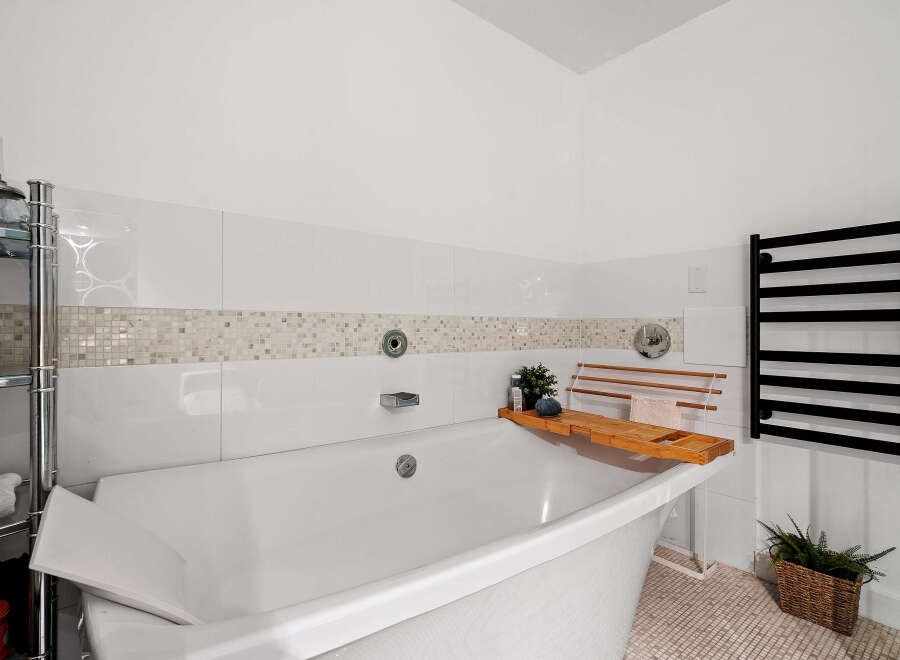 Indulge in relaxation in this luxurious bathroom, featuring a deep soaking tub perfect for unwinding.