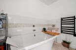 Indulge in relaxation in this luxurious bathroom, featuring a deep soaking tub perfect for unwinding.