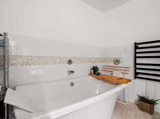 Indulge in relaxation in this luxurious bathroom, featuring a deep soaking tub perfect for unwinding.