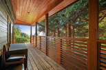 Enjoy breathtaking views from this expansive wooden deck, perfect for outdoor living and entertaining.