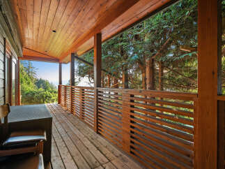 Enjoy breathtaking views from this expansive wooden deck, perfect for outdoor living and entertaining.