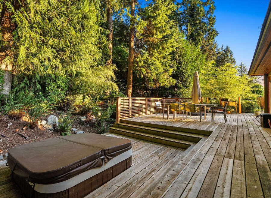 Experience outdoor living at its finest with this expansive wooden deck, perfect for entertaining or relaxing.