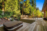 Experience outdoor living at its finest with this expansive wooden deck, perfect for entertaining or relaxing.