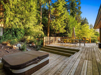 Experience outdoor living at its finest with this expansive wooden deck, perfect for entertaining or relaxing.