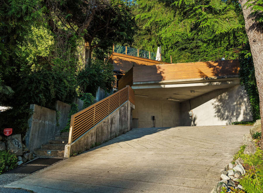 Discover modern living with this stunning property featuring a sleek wooden deck and an integrated garage.