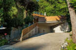 Discover modern living with this stunning property featuring a sleek wooden deck and an integrated garage.