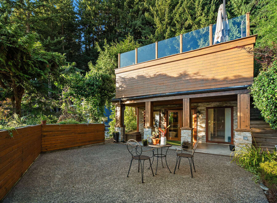 Enjoy outdoor living in this serene backyard featuring a spacious patio area perfect for entertaining.