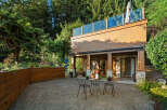 Enjoy outdoor living in this serene backyard featuring a spacious patio area perfect for entertaining.