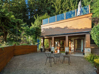 Enjoy outdoor living in this serene backyard featuring a spacious patio area perfect for entertaining.