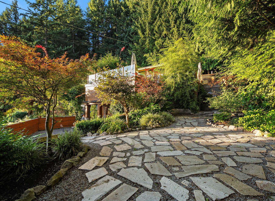 Discover a unique architectural gem nestled amidst lush greenery and vibrant foliage.