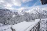 Experience the ultimate winter wonderland from this stunning property, offering breathtaking panoramic views of snow-capped mountains and a charming alpine village nestled in the valley.
