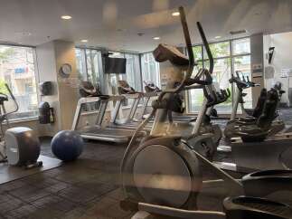 This modern gym features a variety of cardio equipment, including treadmills and ellipticals, perfect for residents to maintain their fitness routine.