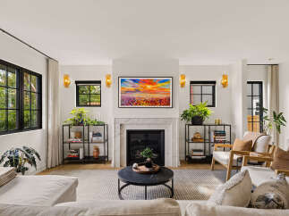 Experience modern living in this beautifully appointed living room, featuring a sleek marble fireplace as the focal point.