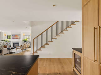 Experience modern living in this beautifully designed home, featuring a sleek open-concept layout that seamlessly connects the living area to a stunning staircase.