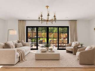 Experience seamless indoor-outdoor living in this beautifully appointed living room, featuring a plush sectional sofa and two accent chairs perfect for relaxation.