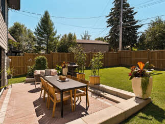 Enjoy outdoor living in this beautifully landscaped backyard featuring a spacious patio perfect for entertaining.