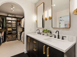 Experience luxury and organization in this stunning master bathroom featuring a spacious walk-in closet.