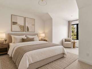 Experience serene living in this beautifully appointed bedroom, featuring a plush king-sized bed adorned with soft, neutral linens and a cozy throw.