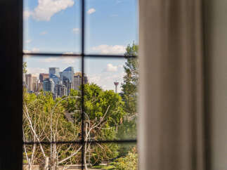 Experience breathtaking city views from this stunning property, framed by the iconic Calgary Tower.