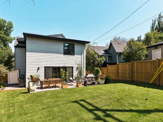 Enjoy outdoor living in this spacious backyard featuring a large, well-maintained lawn perfect for recreation.
