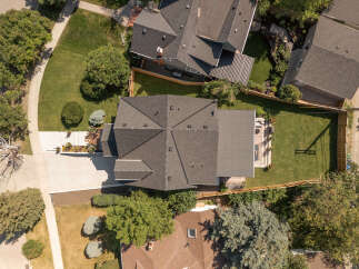 Discover this stunning aerial view showcasing a beautifully maintained property with a spacious backyard perfect for entertaining.