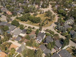 Discover this charming suburban neighborhood from an aerial perspective, showcasing a variety of well-maintained homes nestled amongst mature trees.