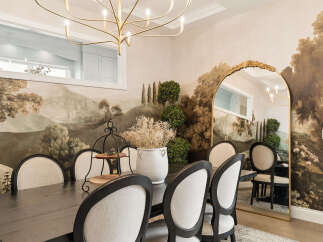 Experience elegant dining in this beautifully appointed space, featuring a dark wood table surrounded by upholstered chairs.