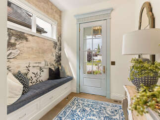 Step into this charming entryway featuring a built-in bench with ample storage, perfect for stowing away shoes and accessories.