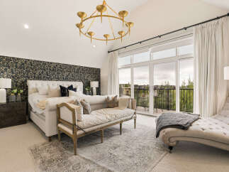 Experience luxury in this master suite featuring a king-sized tufted bed adorned with elegant pillows and a striking botanical wallpaper accent wall.
