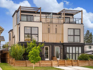 Experience modern urban living in this stunning multi-level townhouse featuring a sleek stucco exterior and expansive windows.