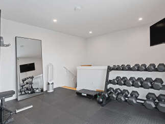 Transform your home into a personal fitness sanctuary with this fully equipped gym space.