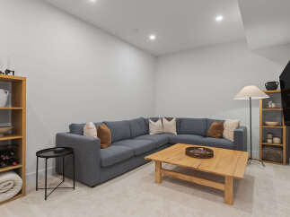 This modern living room features a spacious sectional sofa perfect for family gatherings and entertaining guests.