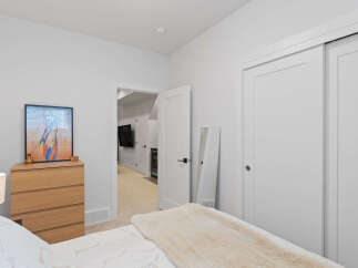 This bedroom offers a serene retreat with its neutral color palette and natural wood accents.