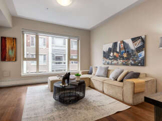 Experience modern living in this stylish living room, featuring a spacious sectional sofa perfect for relaxation and entertaining.