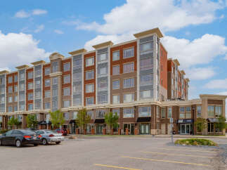 Discover modern urban living in this stunning multi-story apartment building, featuring a striking facade of brick and contemporary accents.