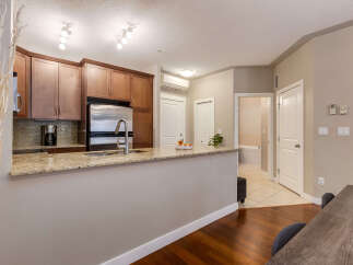 Discover this charming kitchen featuring granite countertops, stainless steel appliances, and ample cabinet space.