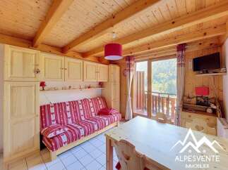 Charming mountain retreat featuring a cozy living area with a pull-out sofa and ample built-in storage.