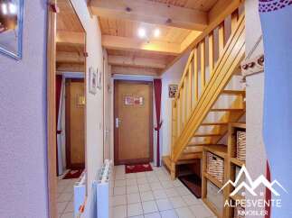 Discover this charming property featuring a warm and inviting interior with exposed wooden beams and a beautiful staircase.