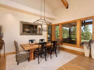 Experience elegant dining in this spacious room, featuring a live-edge wood table and comfortable seating.