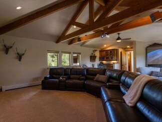 Experience ultimate relaxation in this spacious living room, featuring a large, plush sectional sofa perfect for movie nights.
