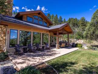 Experience luxurious mountain living with this stunning home featuring a spacious patio perfect for outdoor entertaining.