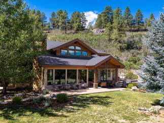 Nestled amidst a picturesque mountain landscape, this stunning home offers an ideal blend of rustic charm and modern luxury.