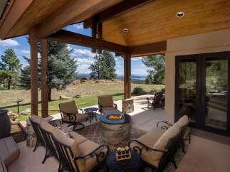 Experience breathtaking mountain views from this stunning covered patio, perfect for entertaining or relaxing.