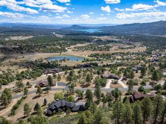 Discover this stunning property offering breathtaking panoramic views of the surrounding mountains and a serene lake.