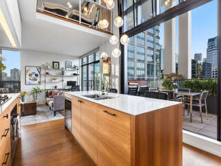 Experience modern urban living in this stunning loft-style condo featuring a spacious open-concept living area with soaring ceilings and abundant natural light.