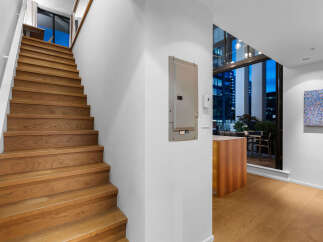 Ascend to modern living with this stunning staircase, featuring rich wood treads and a sleek white railing.
