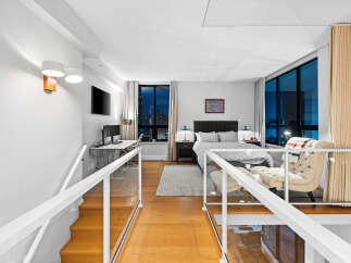 Experience modern loft living with stunning city views from this beautifully appointed bedroom.